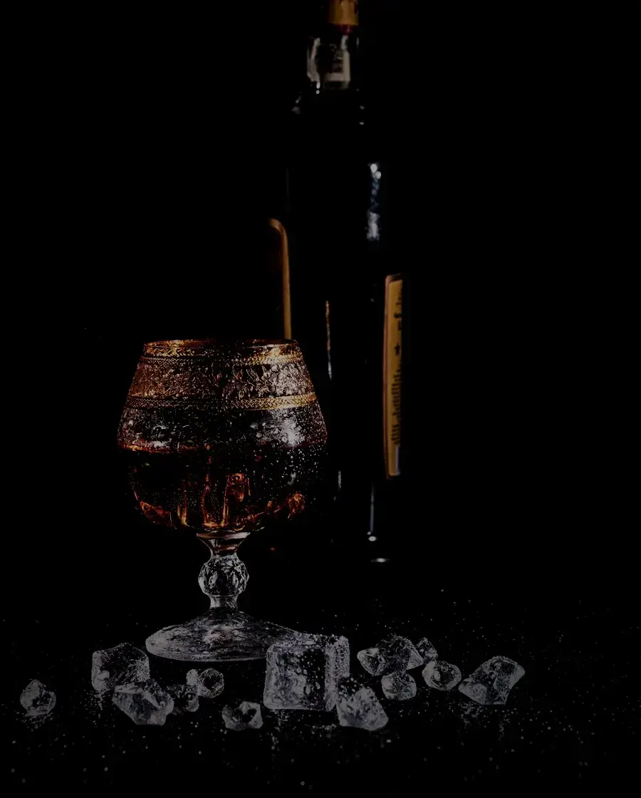 A dark spirit over ice on a wooden table — Khukuri Spiced rum, delivered across Kathmandu Valley by Raksi Hour.