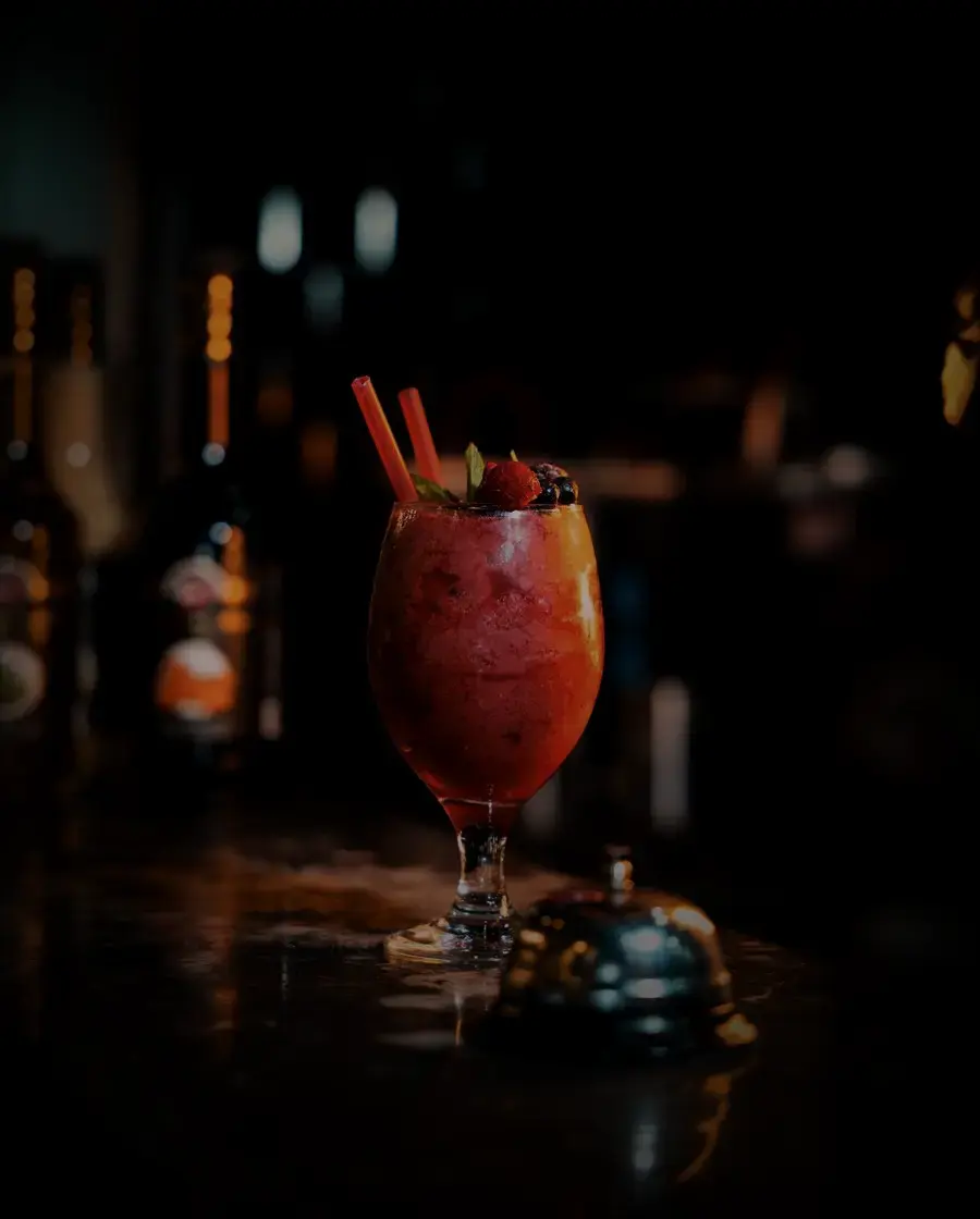 A dark mixed drink on a bar counter — Old Durbar Black Chimney, delivered across Kathmandu Valley by Raksi Hour.